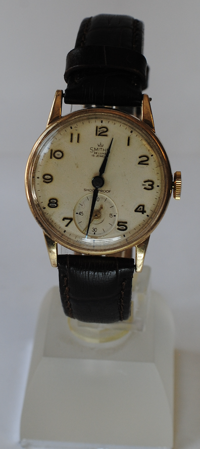 9ct gold Smiths de luxe manual wrist watch on a brown leather strap