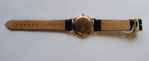 Onsa 14ct gold manual wrist watch with black leather strap back